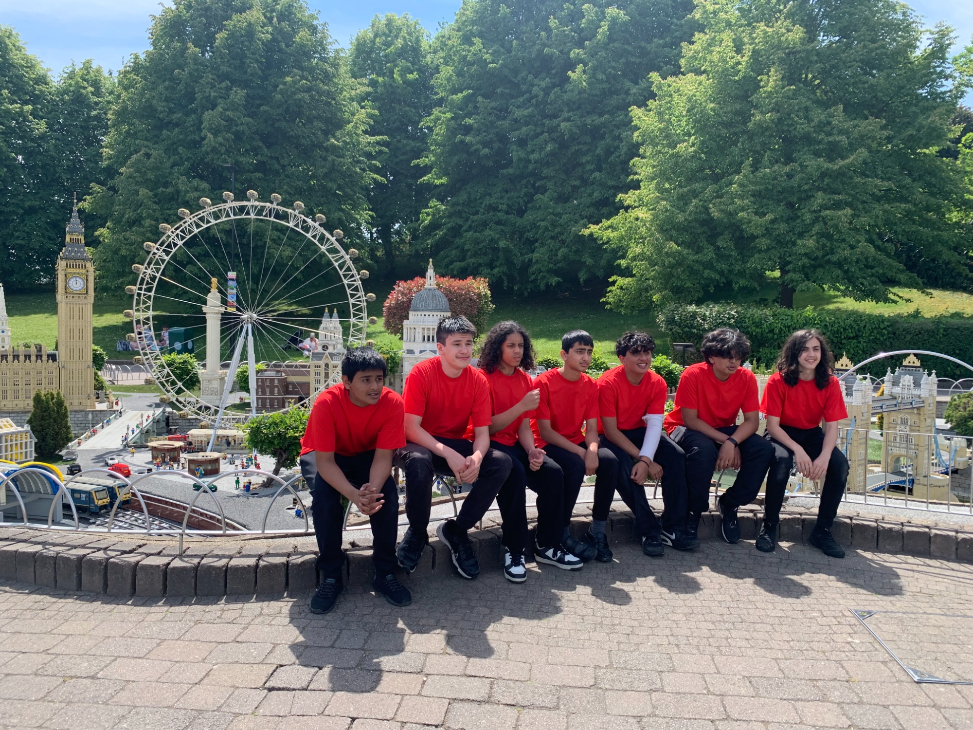 Robotics team sitting in front of lego london scene