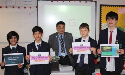 Mr Wong and YGD club students holding posters for the game creations 